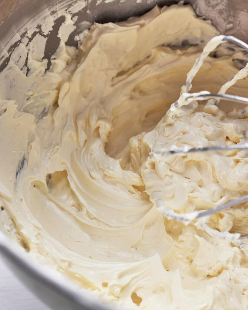bowl of russian buttercream being whipped up.