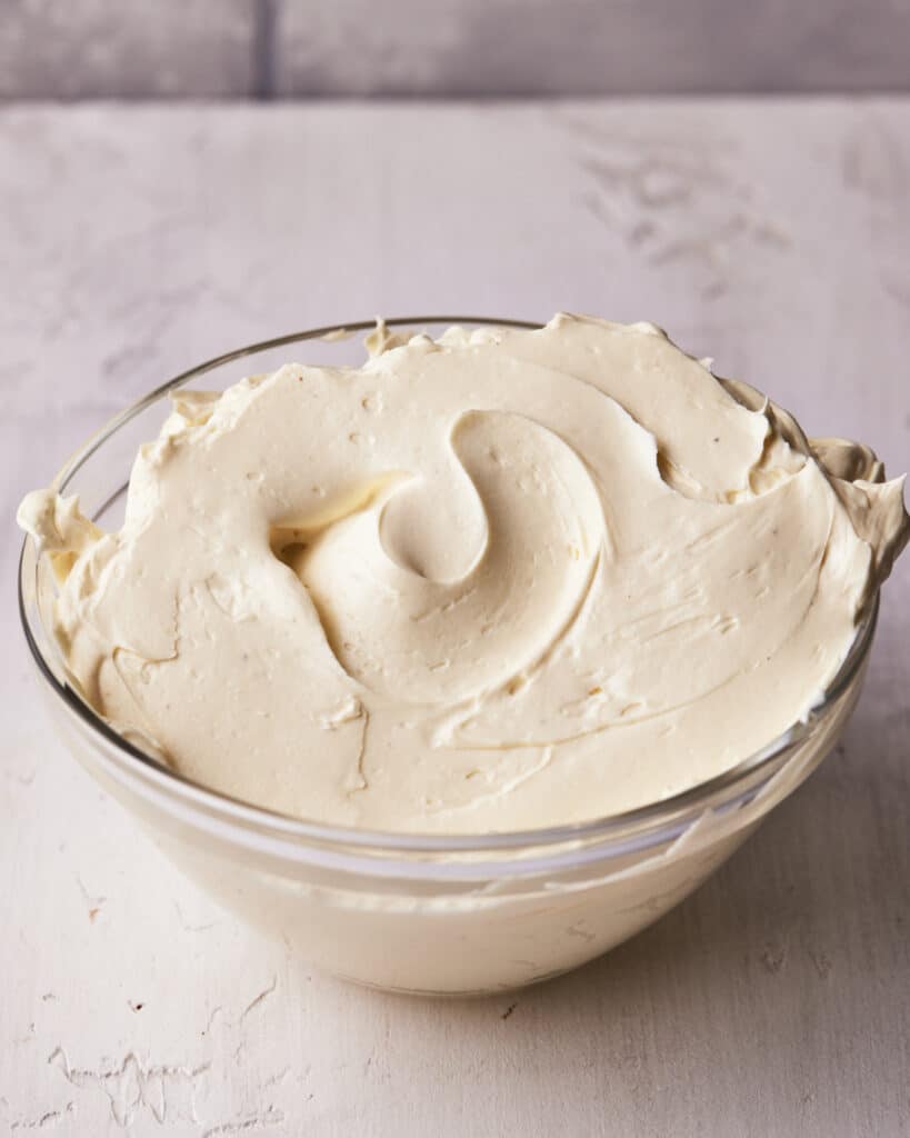 bowl of russian buttercream with a swirl in the middle.