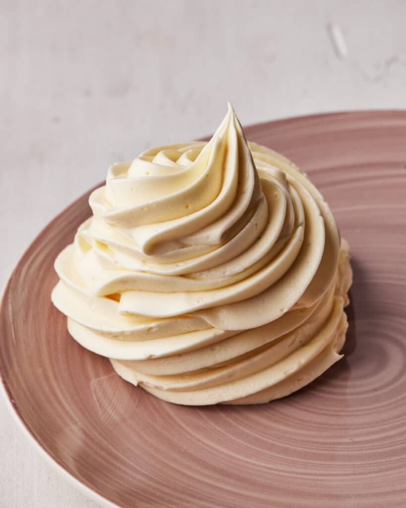Swirl of russian buttercream piped onto a plate.