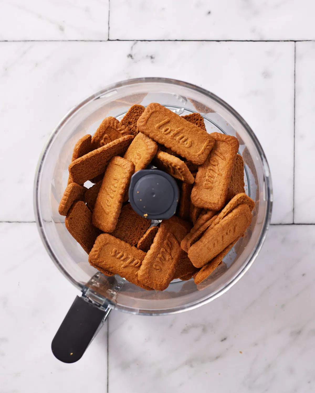 lotus biscuits in a food processor ready to be crushed for biscoff cheesecake base. 