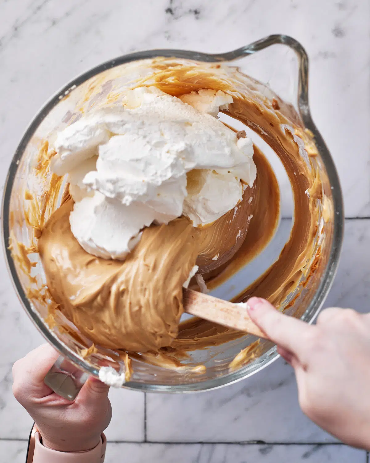 folding cream into cheesecake batter for biscoff cheesecake.