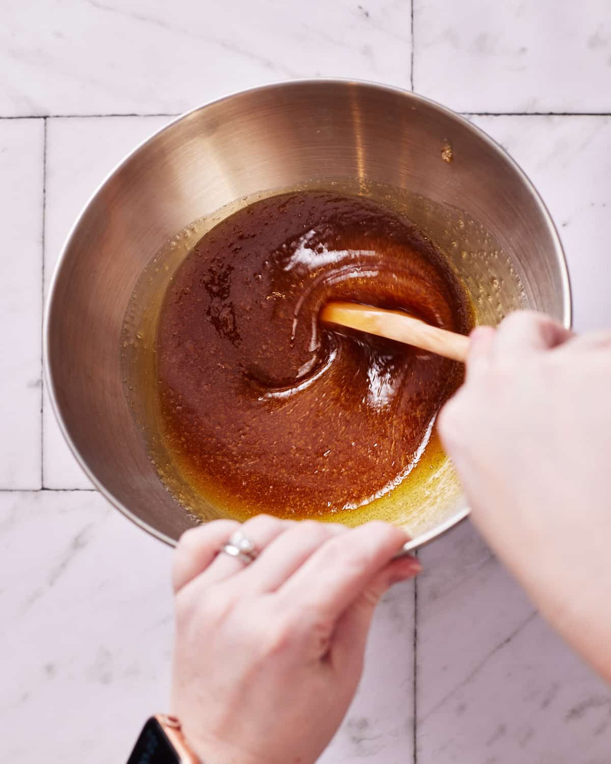 stirring maple syrup to make maple cream.