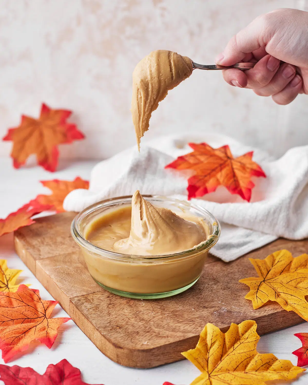 maple cream being spooned out of a jar. 