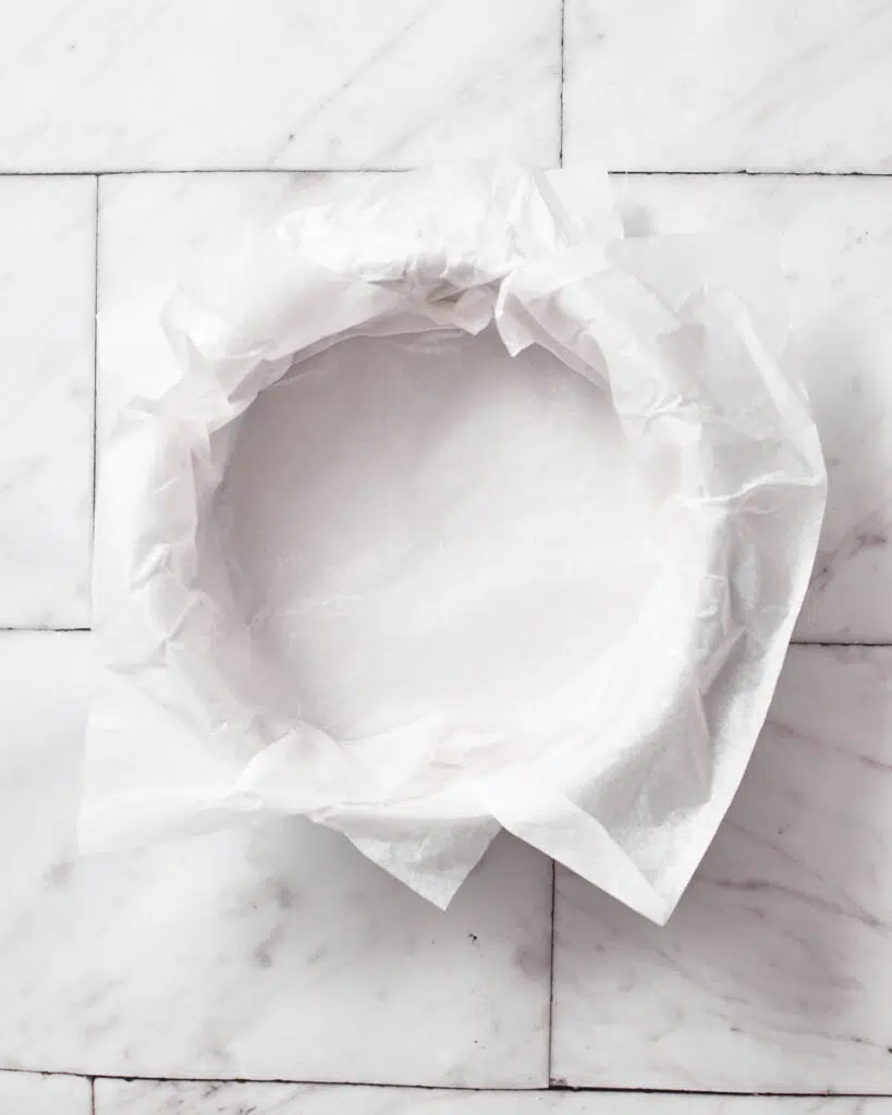cake pan lined with parchment paper for burnt basque cheesecake.
