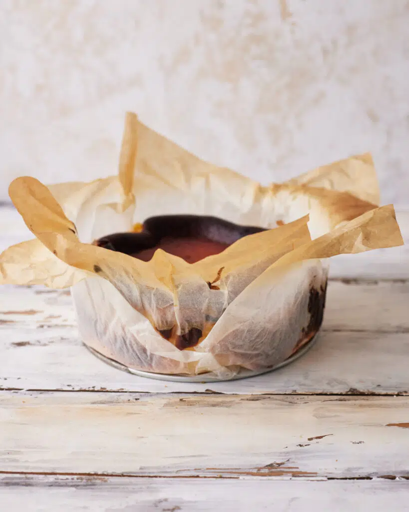 san sebastian cheesecake removed from the pan, still in parchment paper.