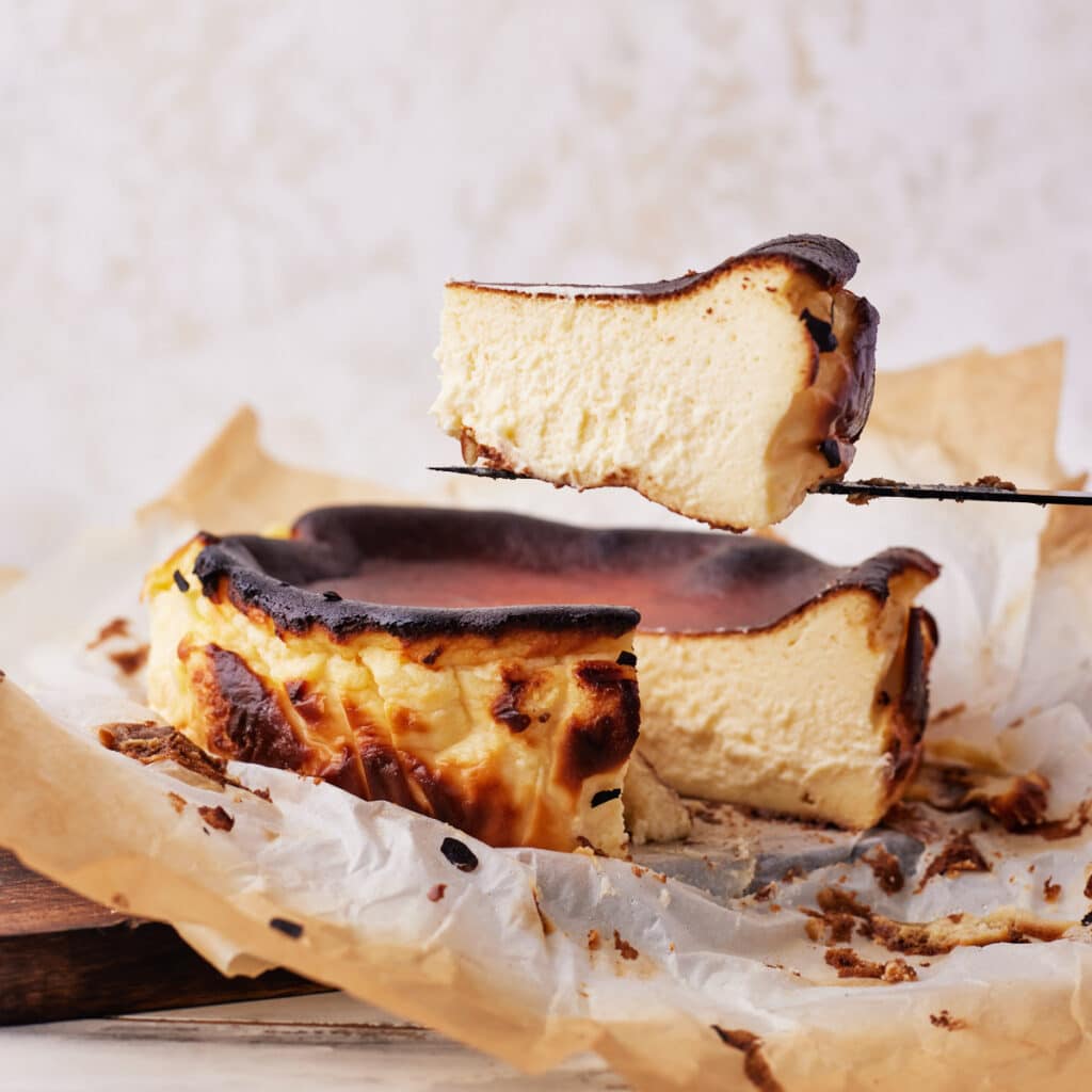 San sebastian cheesecake with slice being taken out.