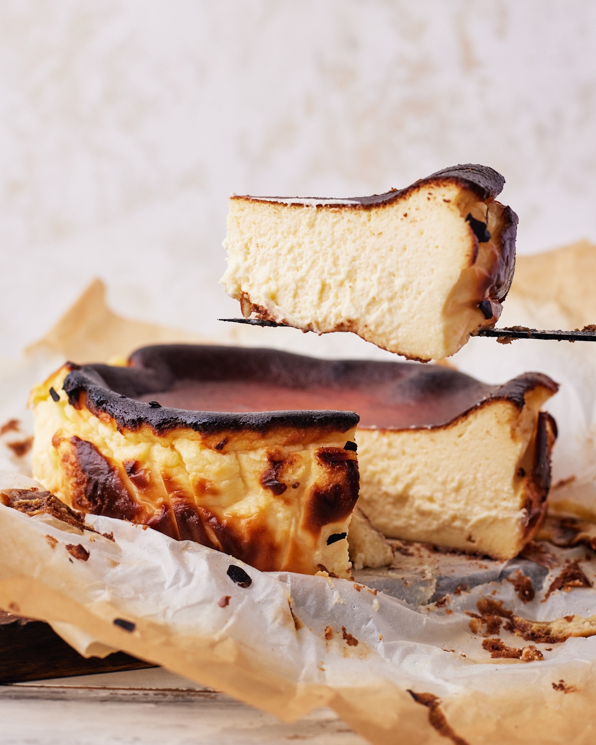 san sebastian burnt basque cheesecake with a slice being cut out. 