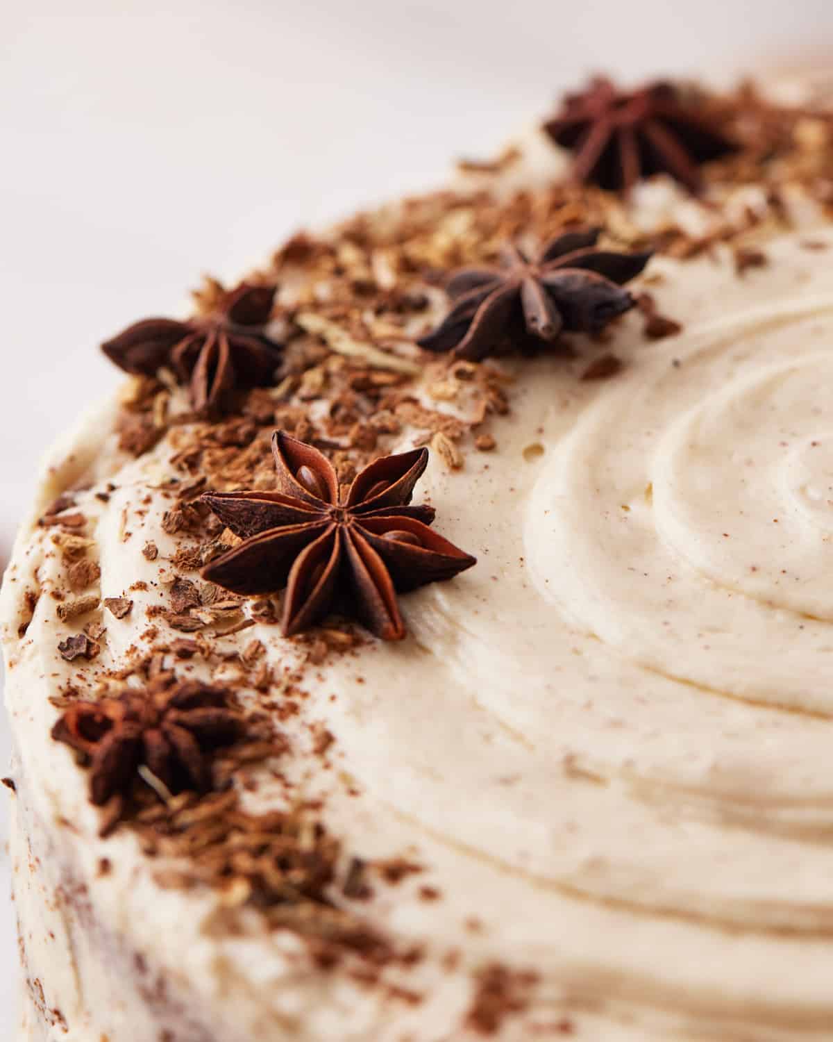 top of chai cake decorated with brown butter frosting, cinnamon and star anise.