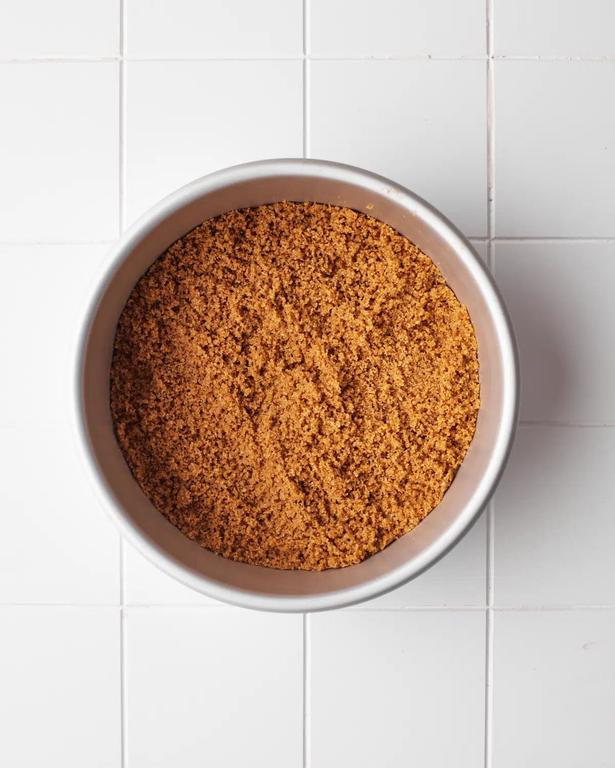 process shot of cinnamon graham cracker crust being made.