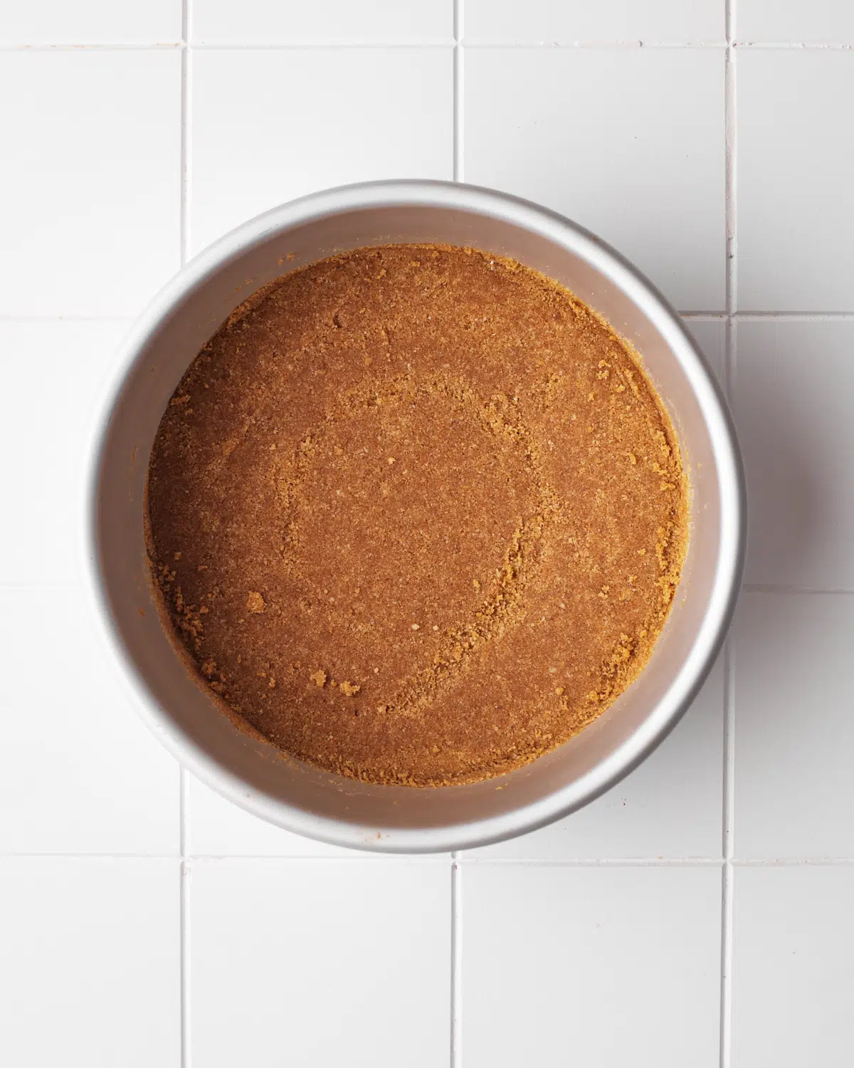 process shot of cinnamon graham cracker crust being made.