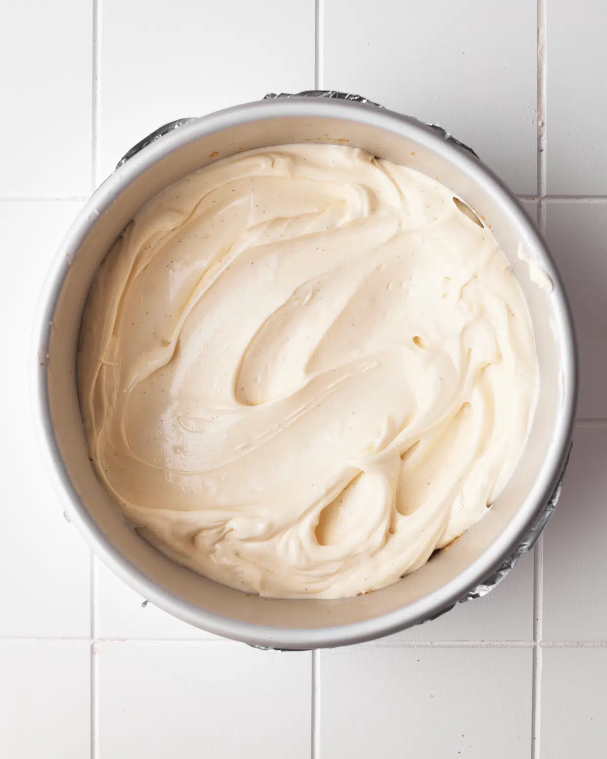 process shot of cinnamon roll cheesecake being assembled.