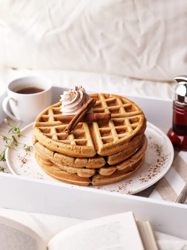 cinnamon waffles being served on a tray in bed.