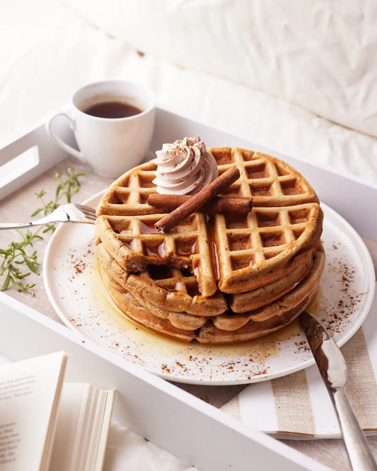 breakfast in bed - cinnamon waffles with cinnamon whipped cream, with bite taken out. 