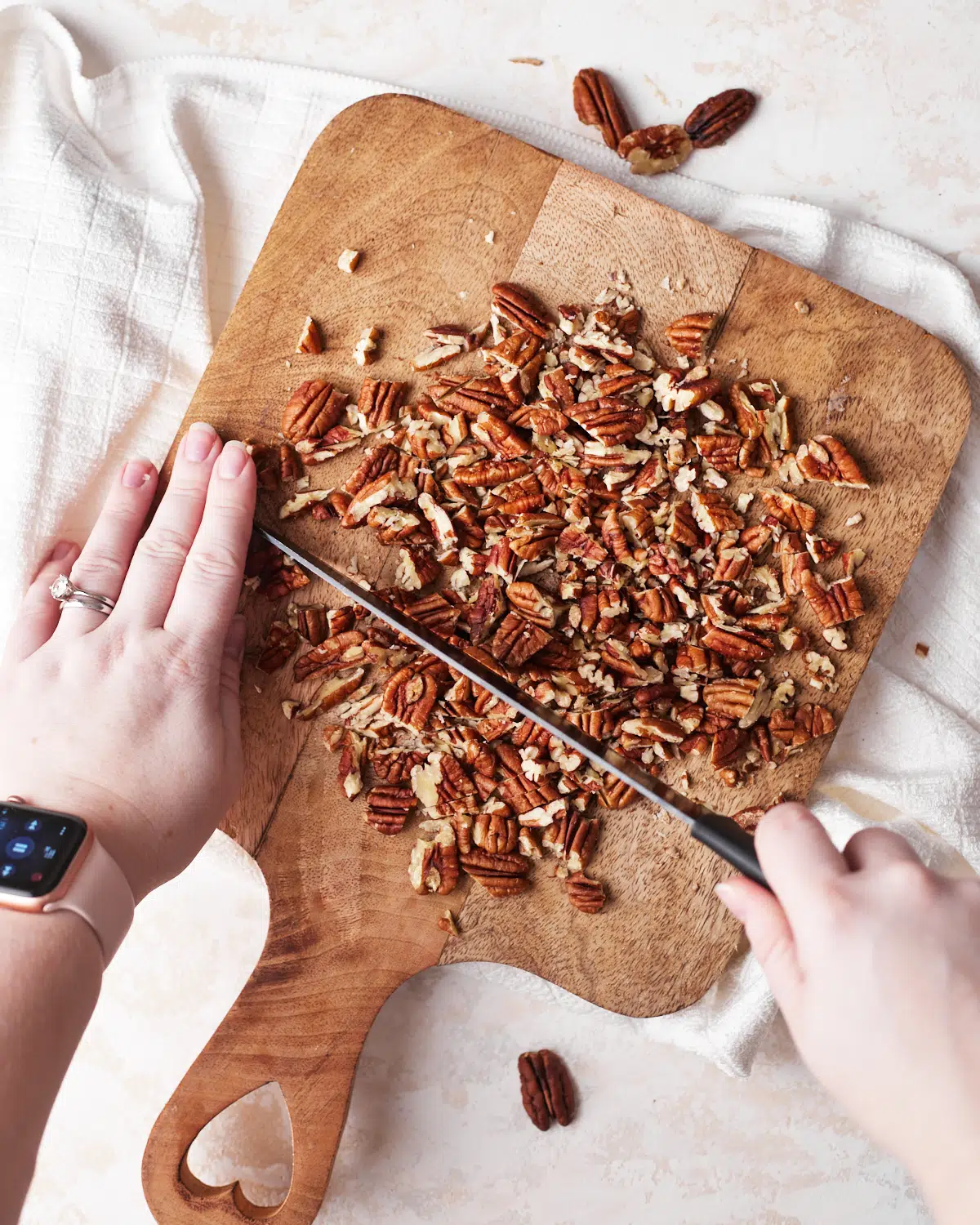 pecans being chopped for coconut pecan cookies. 