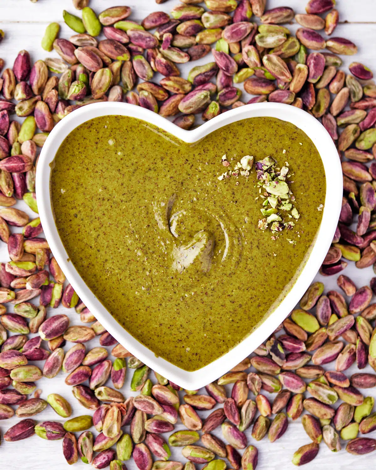 homemade pistachio butter in a heart shaped bowl.