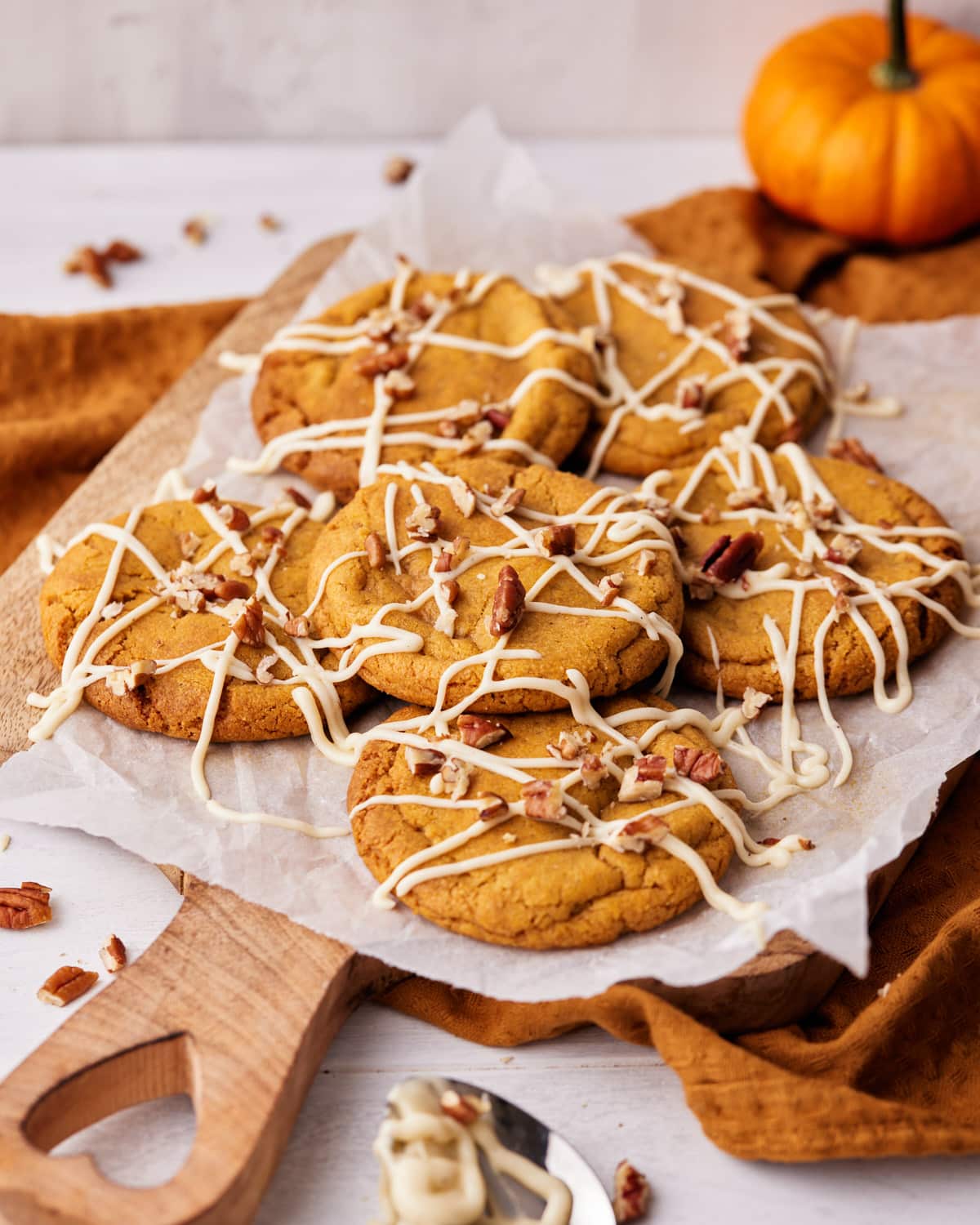 pumpkin cheesecake cookies decorated with cream cheese glaze. 