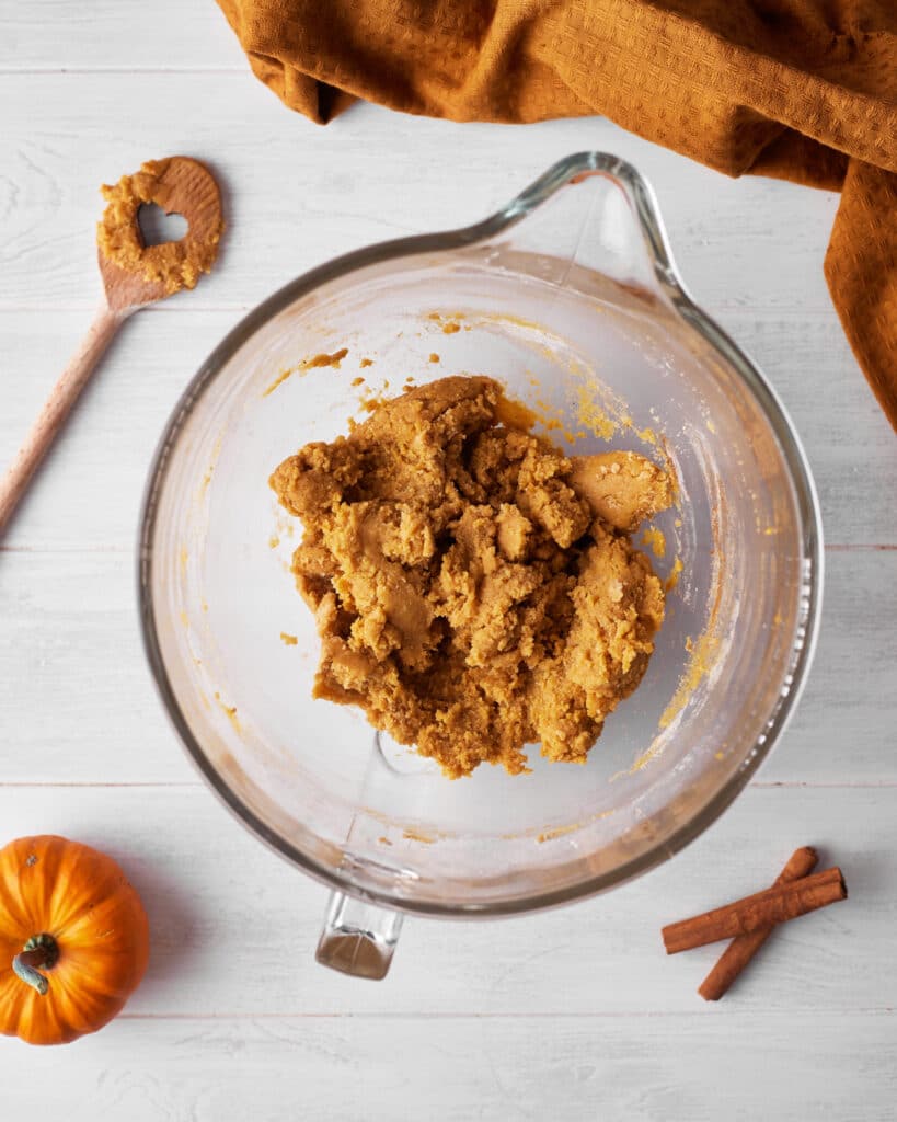 pumpkin cookie dough in a bowl ready to be scooped. 