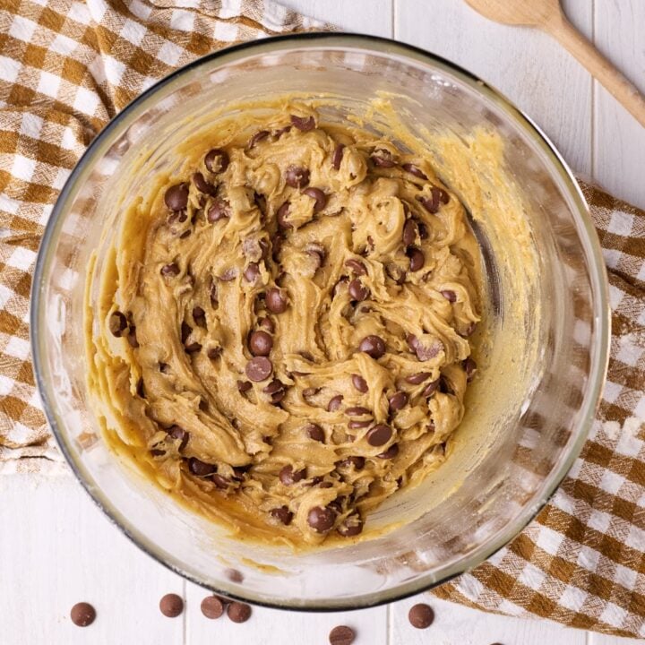 Bowl of edible cookie dough on a brown tea towel.