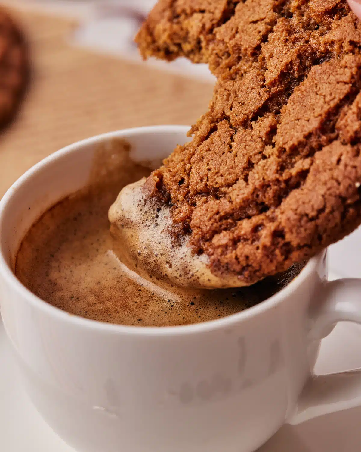 coffee cookie being dipped into an espresso.