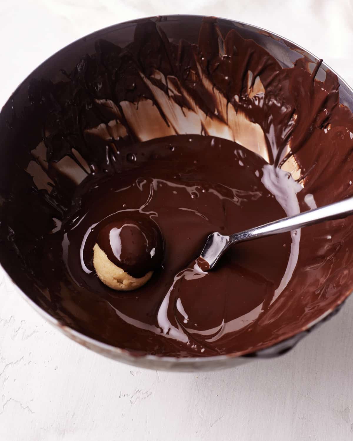 dipping cookie dough bites in melted chocolate