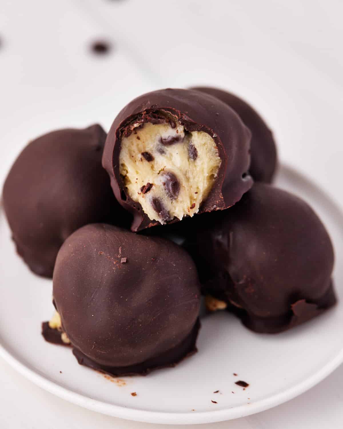 pile of chocolate covered edible cookie dough bites. 