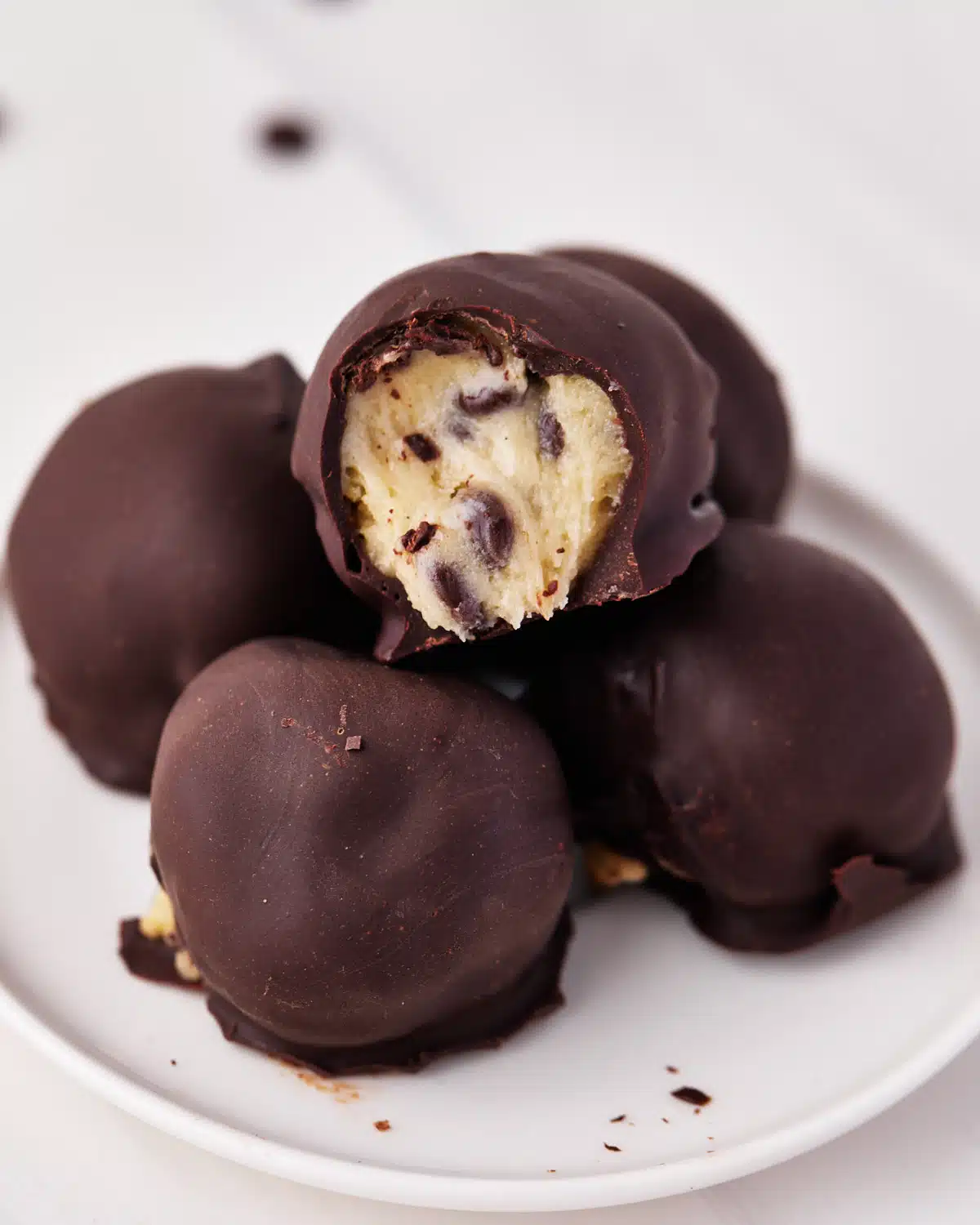 pile of chocolate covered edible cookie dough bites. 