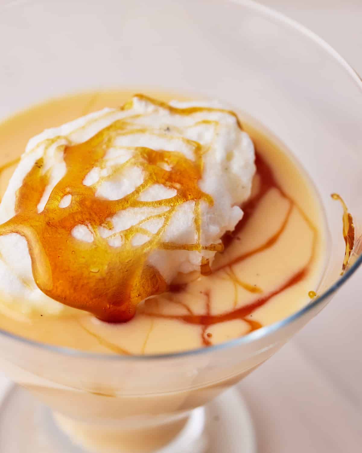 close up of floating island with caramel sauce