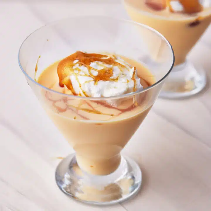 Floating islands dessert in a glass serving dish.