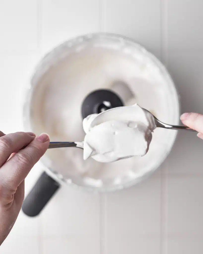 shaping meringue for poaching to make floating island dessert.
