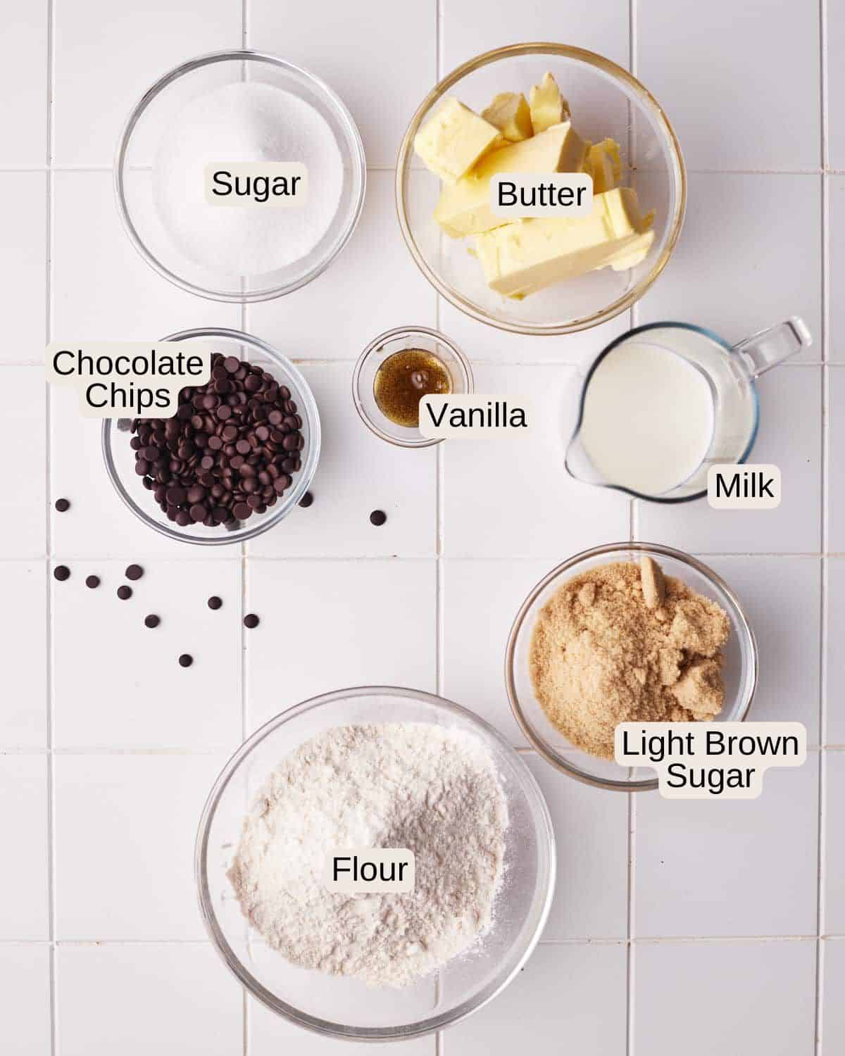 Ingredients to make edible cookie dough bites, including sugar, butter, chocolate chips, vanilla, milk, light brown sugar, and flour.