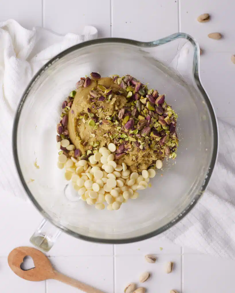chopped pistachios and white chocolate chips in pistachio cookie dough.
