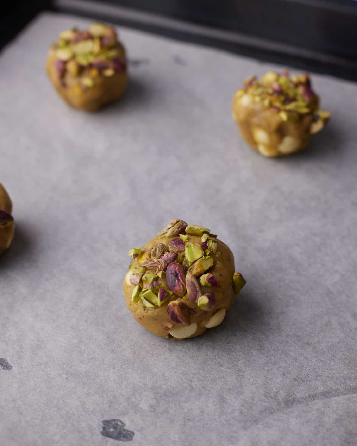 rolled balls of pistachio cookie dough.