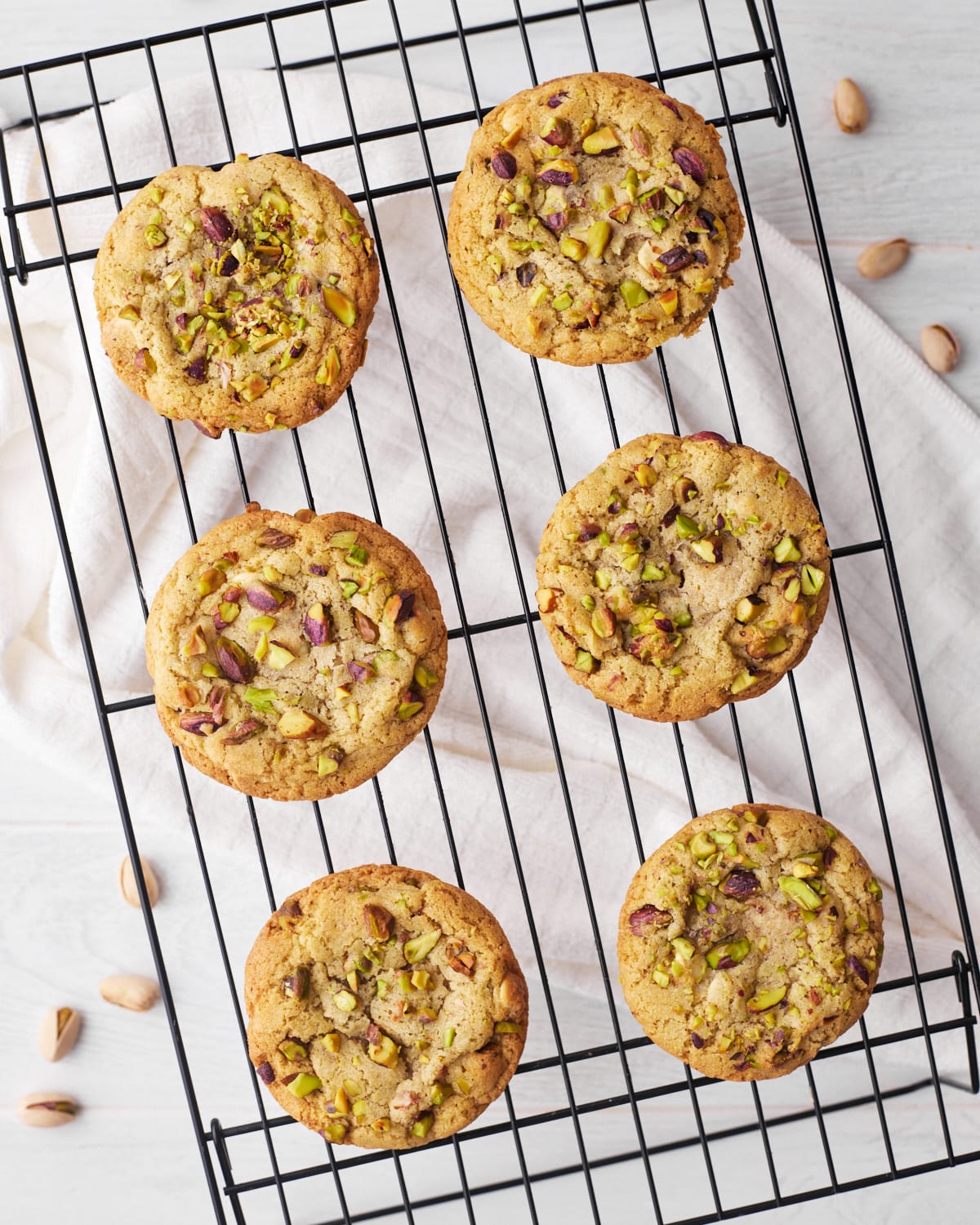 baked pistachio cookies on a cooling rack.