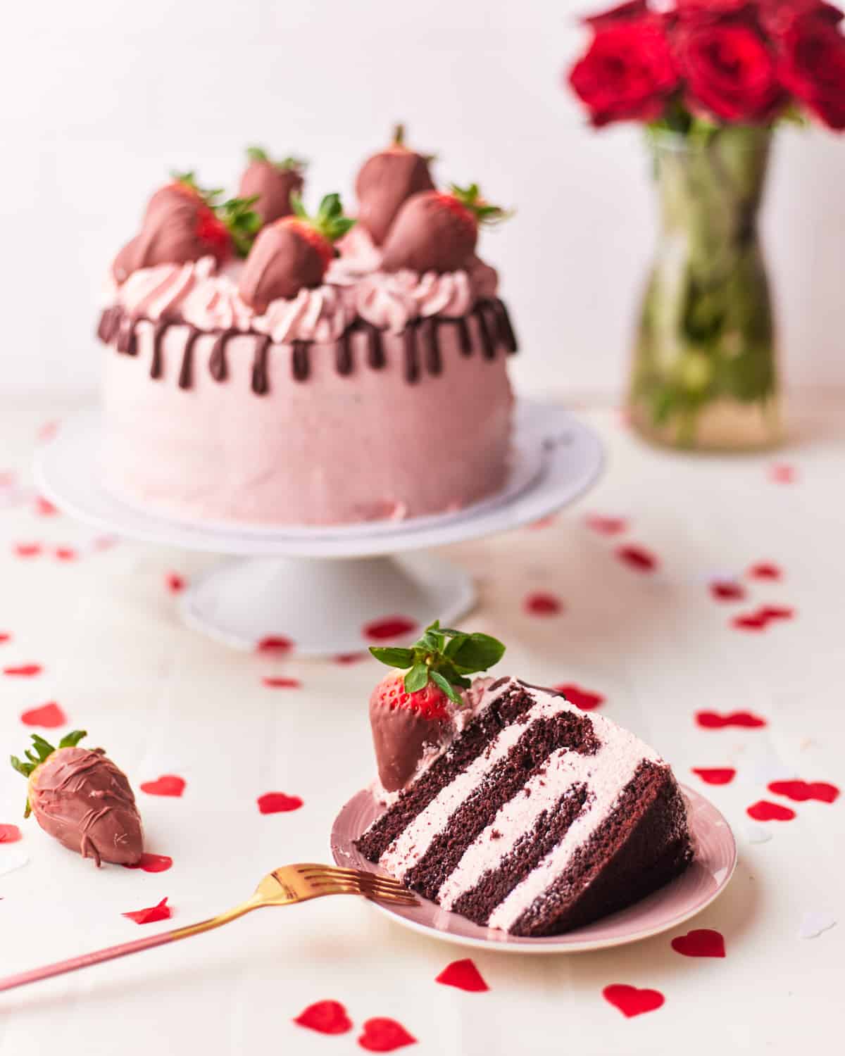 chocolate strawberry cake with chocolate drip and chocolate covered strawberries.