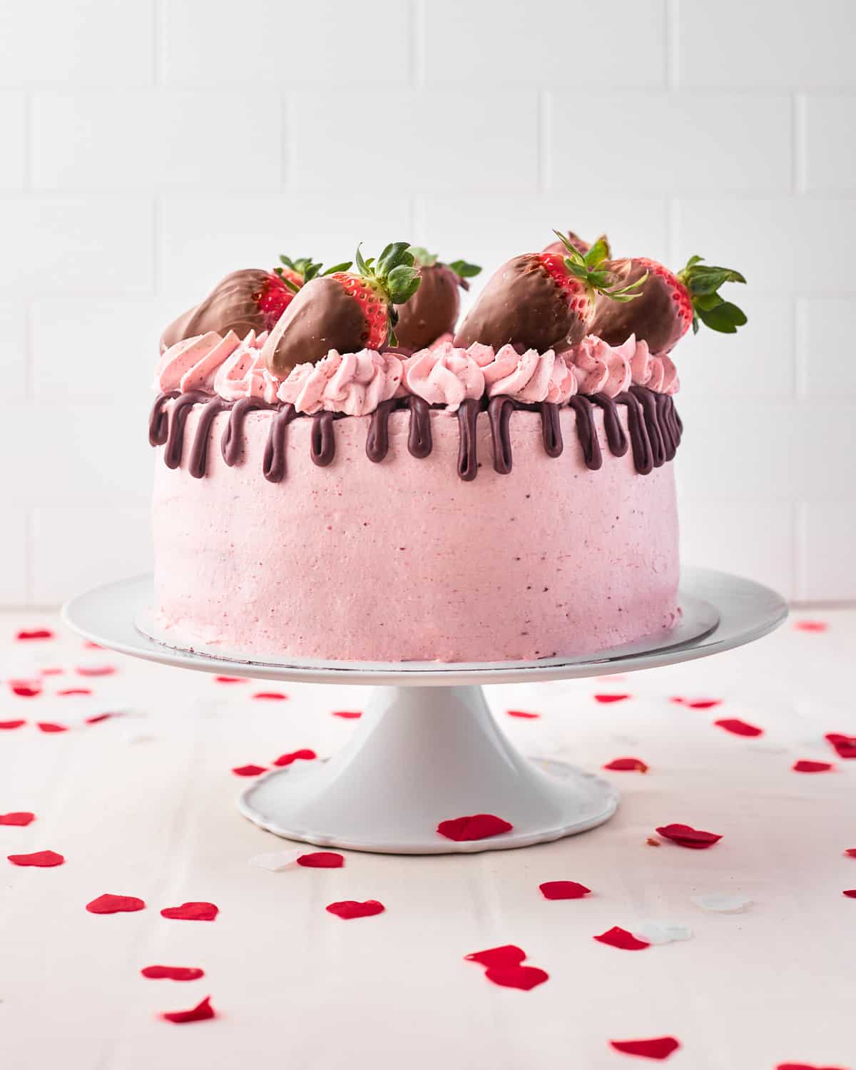 chocolate strawberry cake with chocolate drip and chocolate covered strawberries.