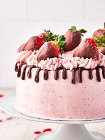 chocolate strawberry cake with chocolate drip and chocolate covered strawberries.