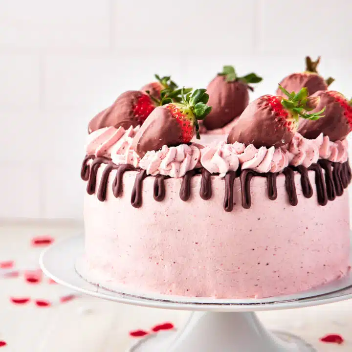 chocolate strawberry cake with chocolate drip and chocolate covered strawberries.