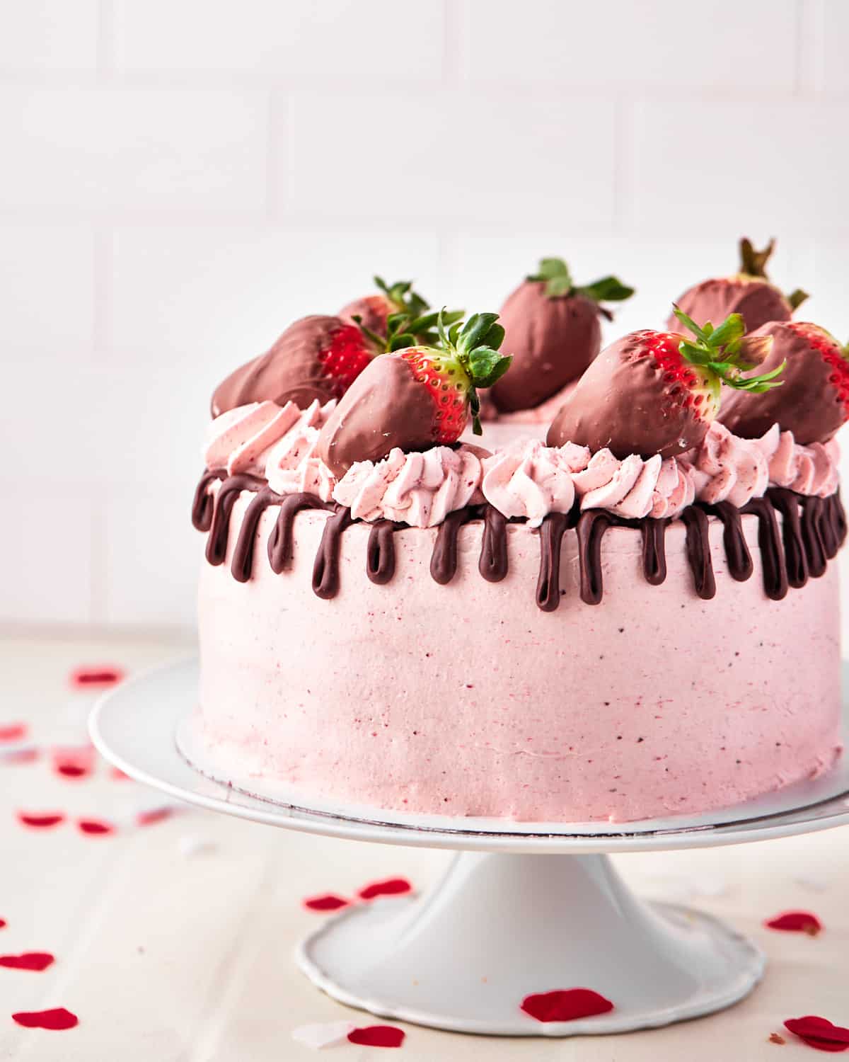 chocolate strawberry cake with chocolate drip and chocolate covered strawberries. 