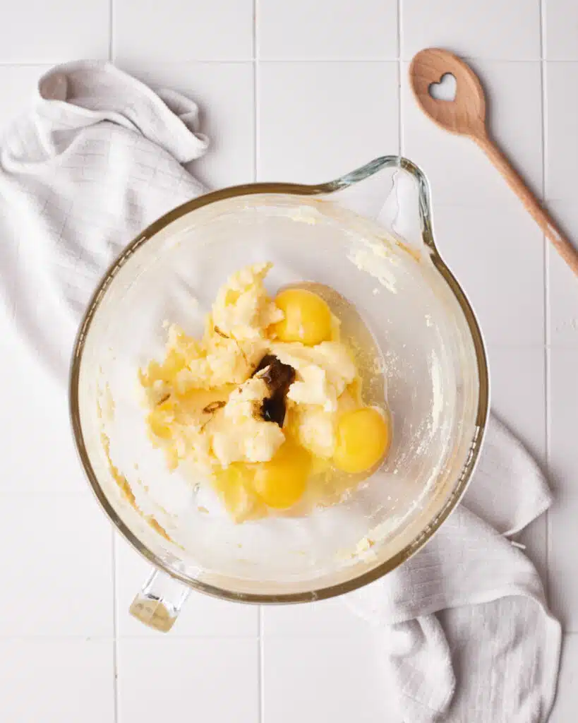 process shot - adding eggs and vanilla to mini bundt cake batter.