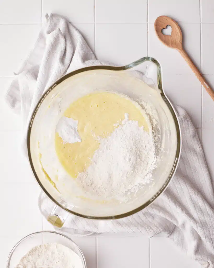 adding dry ingredients to mini bundt cake batter.