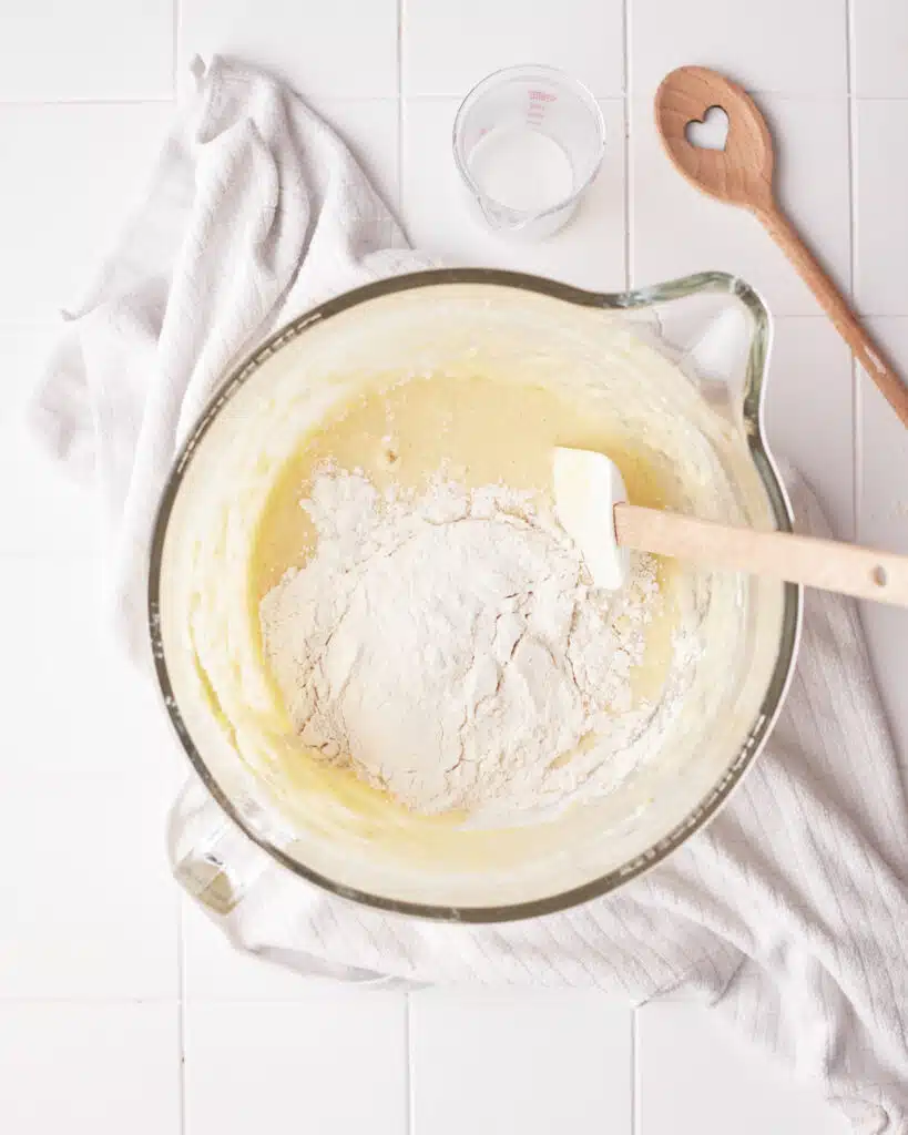 adding dry ingredients to mini bundt cake batter.