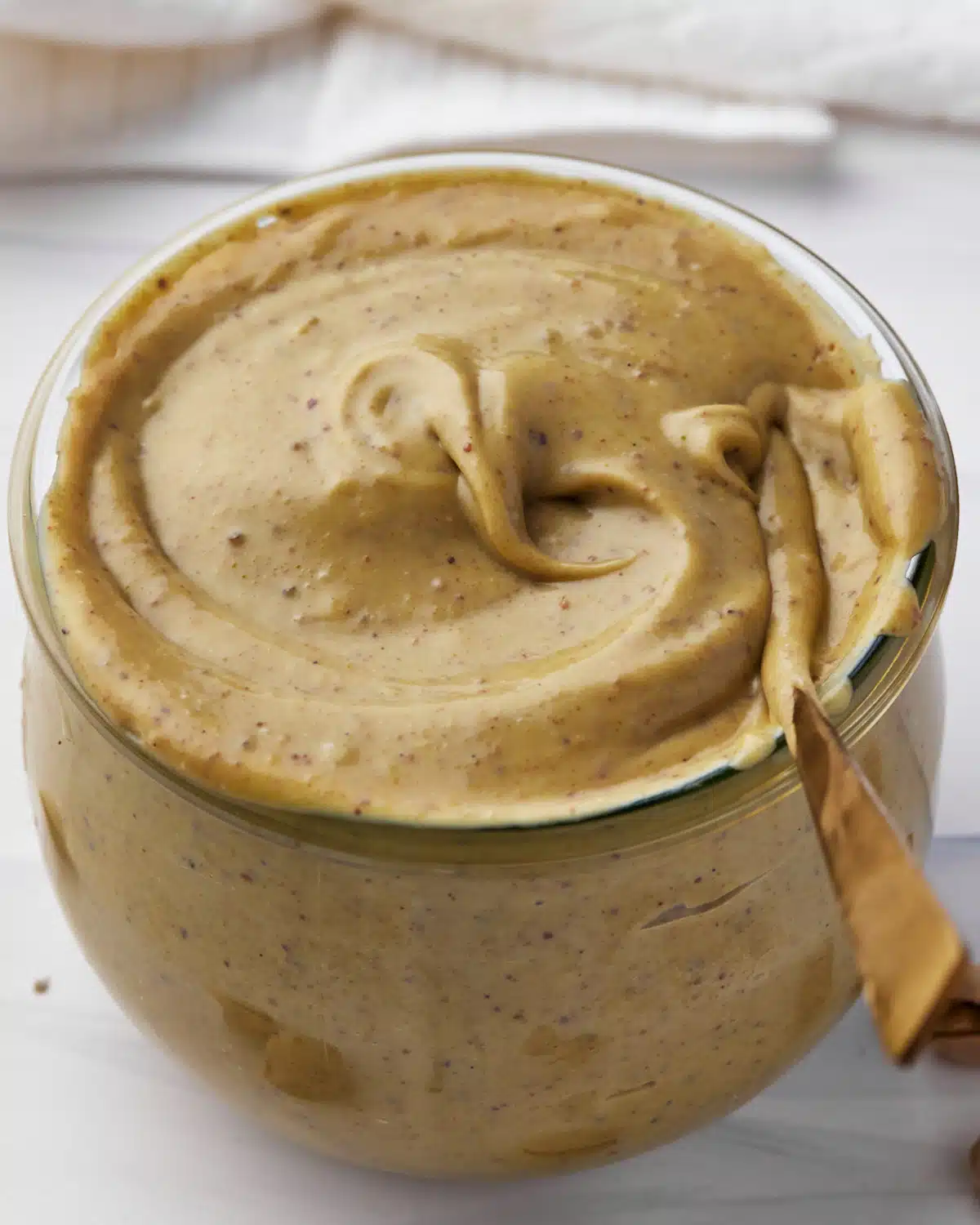 close up of pistachio cream in a jar. 