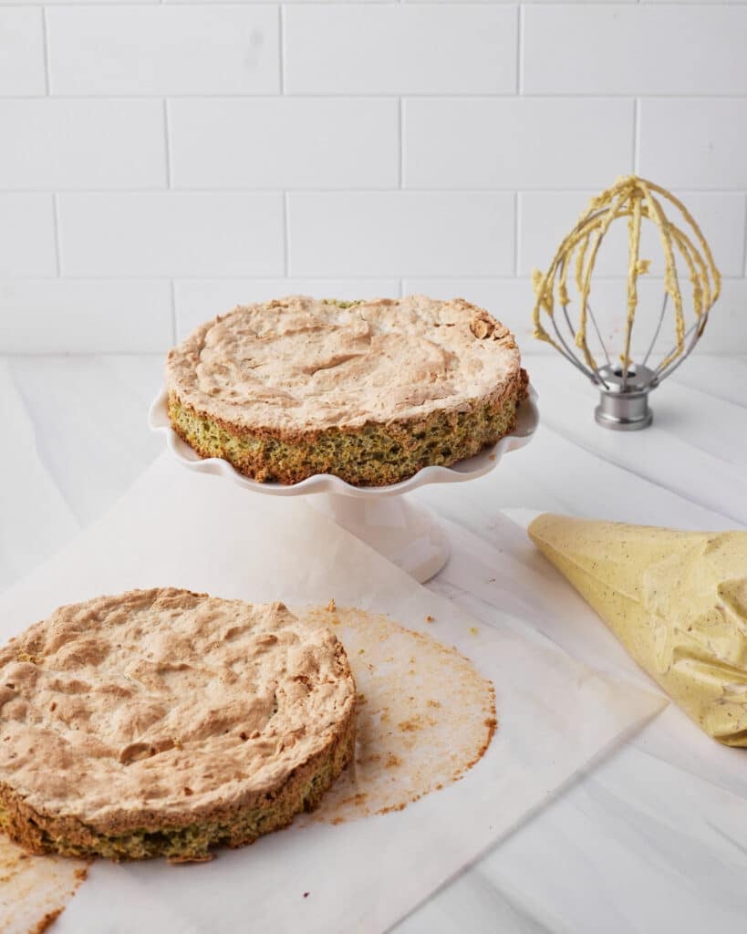pistachio dacquoise cake ready to be decorated with pistachio french buttercream.