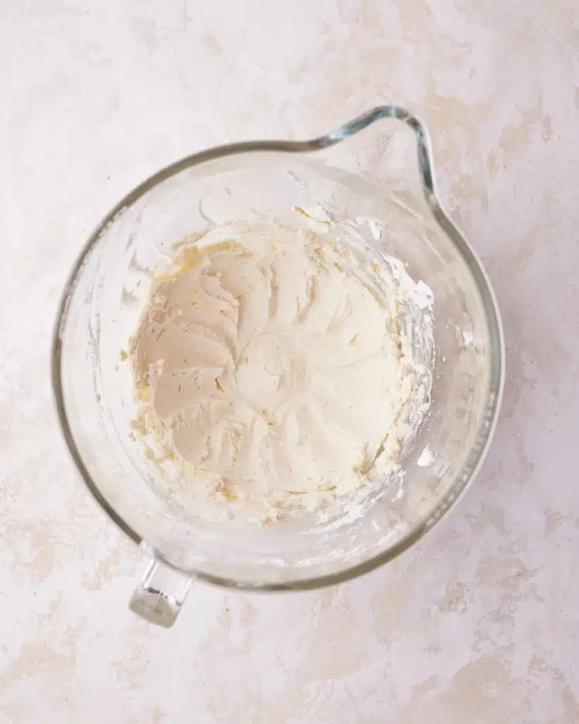 process shot of making mascarpone cream for tiramisu cookies.