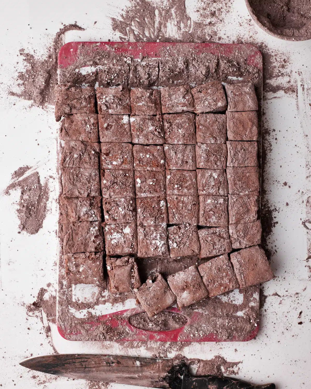 Cutting up chocolate marshmallows into squares