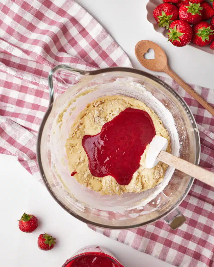 process shot for strawberry brownies, strawberry puree being added to the brownie batter.