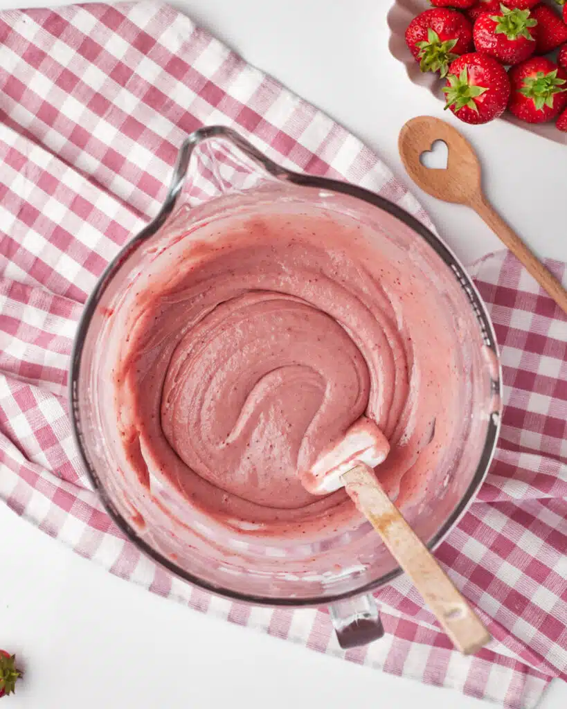 process shot for strawberry brownies, lovely pink strawberry brownie batter being mixed together.
