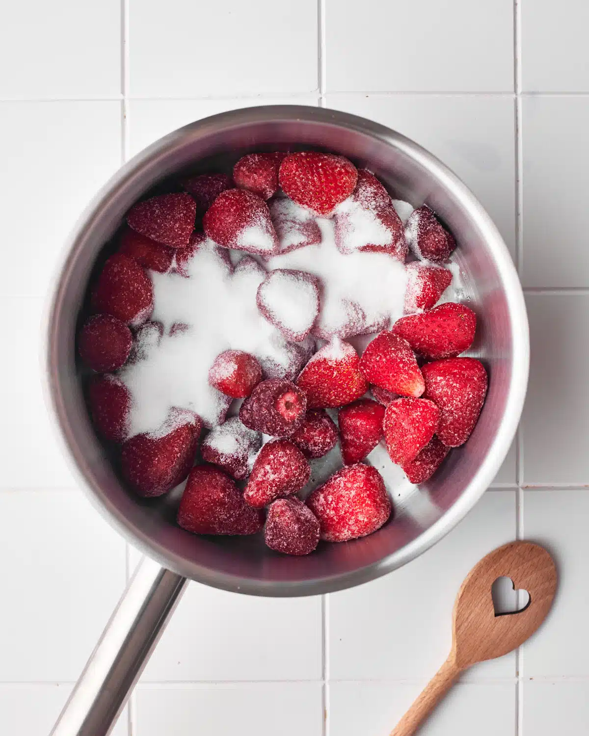 strawberries and sugar in a saucepan, ready to make strawberry puree. 