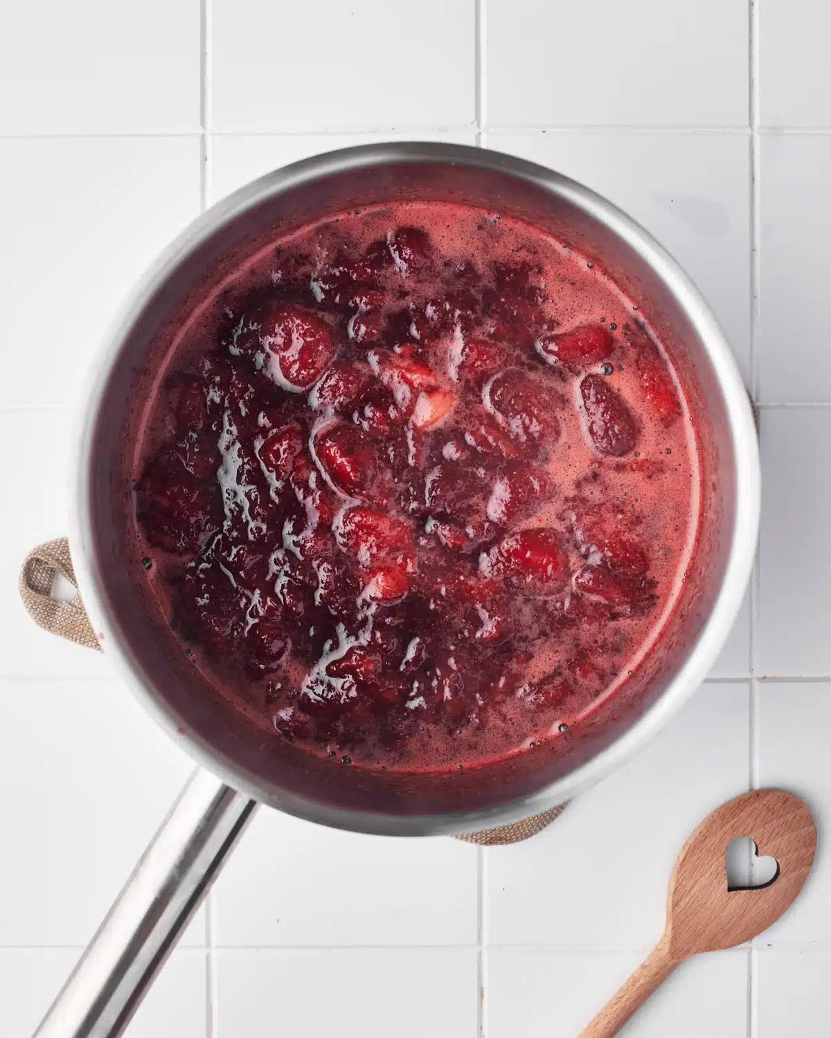 process shot of strawberry puree - strawberries starting to break down in the pan. 