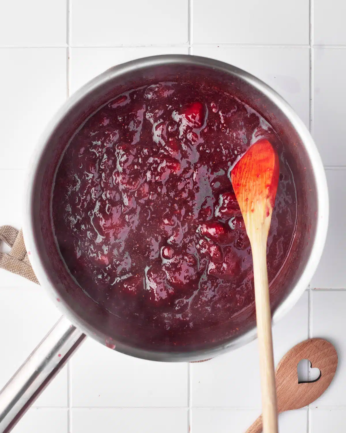 reduced strawberry puree has thickened in the pan.